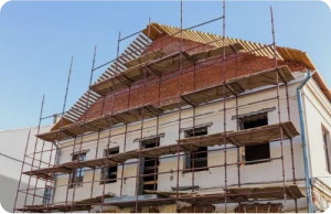 Rehabilitación de fachadas 2 Tejados Alcala Henares tiled_roof_against_blue_sky_with_clouds_idea_background_with_space_text_ecofriendly_traditional_roofs_home_1
