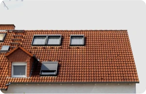 Instalación de Claraboyas 5 Tejados Alcala Henares tiled roof against blue sky with clouds idea background with space text ecofriendly traditional roofs home 1 16 - Tejados Alcala Henares