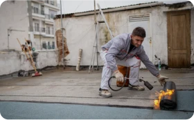 Rehabilitación de fachadas 4 Tejados Alcala Henares Técnico en proceso de rehabilitación de fachadas, aplicando capas impermeabilizantes para reforzar la protección y mejorar la durabilidad del edificio